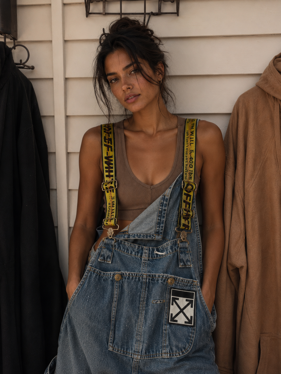 Blue reconstructed overall dress with industrial yellow straps and editorial portrait styling